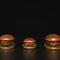 Three Different Sizes of Delicious Hamburgers Displayed on Black Background