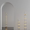 Three Transparent Glass Floor Lamps With Golden Ring Decorations And White Arched Mirror