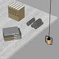 Neatly Stacked Books And Magazines On Dark Wooden Table With Scrolls And Hanging Lamp