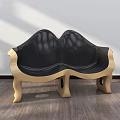 Modern Public Chair With Curved Design Black Leather Seat And Golden Legs On Wooden Floor