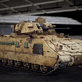 Two Sand Colored Military Tanks With Tracks Parked In Industrial Warehouse