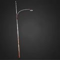 Outdoor Street Light with Curved Arm and Metal Pole Lit Up Bright White at Night