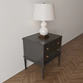 Black Wooden Nightstand With White Table Lamp On Light Wall And Wooden Floor