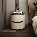 Modern Beige Nightstand With Black Top Drawers Stacked Books And Decorative Ornament