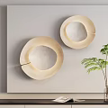 Sleek Two Beige Wall Lamps Mounted on Light Colored Wall With Green Plant and Vase