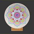 Intricate White Ceramic Plate Sculpture with Colorful Mandala Pattern on Orange Base