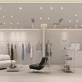 Modern Clothing Store Interior Design With Clothes On Racks Sofa Chair Reception Desk And Plant