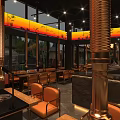 Modern Upscale Restaurant Interior With Warm Ambient Lighting Complete Bar And Comfortable Dining Seats