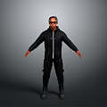 Man Wearing Sunglasses In Black Jacket And Pants Standing With Arms Outstretched Against Gray Background