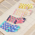 Colorful Patterned Socks Laid Out On Wooden Drying Rack With Mesh Cloth