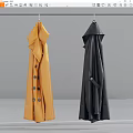 Two Stylish Yellow And Black Trench Coats Hanging On Gray Background