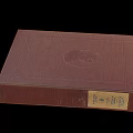 Brown Leather Bound Book With Circular Emblem On Cover And Vintage Pages