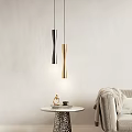 Twisted Silver and Gold Pendant Lights in Living Room with Small Table Decor and Coffee Cup
