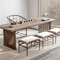 Modern Wooden Tea Table And Padded Stools With Tea Sets Books And Natural Light
