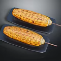 Grilled Corn on Wooden Sticks Served on Black Plates with Yellow Kernels