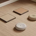 Japanese Style Woven Square Mats And Round Cushions On Wooden Floor