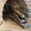 Ancient Cannon In Historical Stone Fortress With Brick Archway Structure