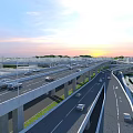 Multi Level Highway Bridge With Cars Driving On Urban Sunset Scene