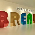 Hotel Public Lounge Area With Please Be Seated Sign And Colorful BREAKS Letters