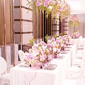 Elegant Banquet Hall Decoration With Long Dining Table White Chairs And Pink Floral Arrangements