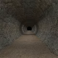 Road Tunnel With Rough Rock Walls Sandy Ground And End Light