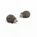 Two Small Spiny Reptile Models With Brown Textured Bodies On White Surface