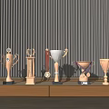 Trophies and Medals Displayed on Wooden Long Table with Black Vertical Striped Wall