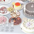 Elegant Dinnerware Set With Assorted Cakes Cookies Candies Plates And Wine Glasses