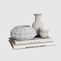 Decorative Ornament Set Featuring Shell Shaped Container Tall Vase and Small Cup on Stacked Books
