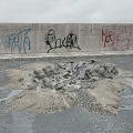 Pile of Stones and Wood Debris Near Graffiti Covered Concrete Wall