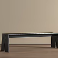 Black Bench With Four Legs On Light Colored Wooden Floor And Beige Wall