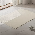 Neutral Woven Square Rug On Gray Tile Floor Near Window With White Blinds And Decorative Ball