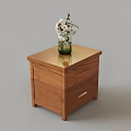 Wooden Nightstand With Smooth Surface And Green Vase Holding White Flowers