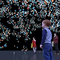 Colorful Bubbles Installation With People Interacting In Dark Background Vibrant Atmosphere