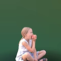 Little Girl Eating Apple In White Sleeveless Dress Seated On Ground Against Green Background
