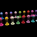 Colorful Small Figurines Art Installation With Vibrant Hues Arranged On Black Background