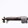 Dark Brown Leather Ottoman with Gray Blanket and Brass Vase in Modern Sleek Design
