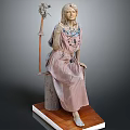 Seated Female Sculpture With Ornate Dress Beaded Necklace And Bird Creature Decoration