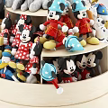 Multi Tiered Rotating Display Shelf With Disney Character Figurines And Light Wood Base 3d model