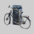 Dirty Old Bicycle Leaning Against Graffiti Covered Urban Trash Can