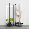 Modern Clothes Rack With Wheels Hanging Clothes And Green Plant For Home Use