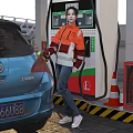Woman in Orange Jacket Refueling Blue Car at Gas Station with Fuel Dispenser