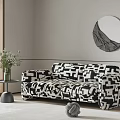 Two Seater Sofa With Black And White Geometric Pattern And Green Plant Round Mirror