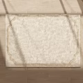 Square Beige Rug With Ornate Border On Wooden Floor And Sunlight Shadows