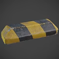 Yellow And Black Striped Traffic Safety Barrier Block With Worn Surface