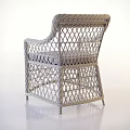Stylish Wicker Armchair With Woven Rattan Structure And Beige Seat Cushion