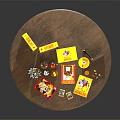 Round Wooden Table Displaying Yellow Boxes Cards CDs And Small Items 3d model