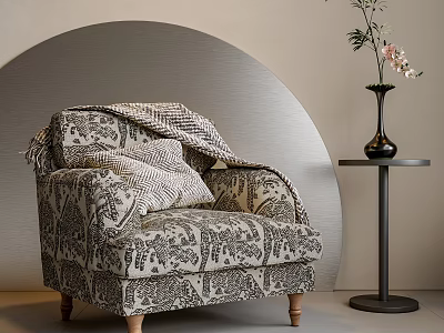 Patterned Fabric Armchair with Blanket and Pillows beside Small Round Table Black Vase Curved Wall 3d model