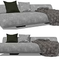 Modern Gray Sectional Sofa with Dark Green and Light Gray Cushions and Striped Throw Blanket