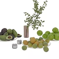 Fresh Avocados Green Apples And Lemons On Glass Plates With Candles Vase And Greenery Branch